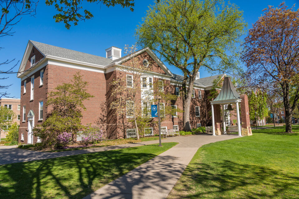 The Bell Tower and Weyerhaeuser Hall in the spring. Trees nearby are starting to bud.