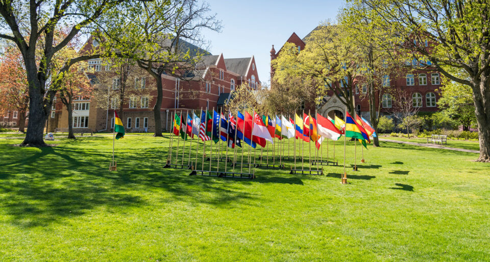 International flags fly on the Great Lawn at Macalester