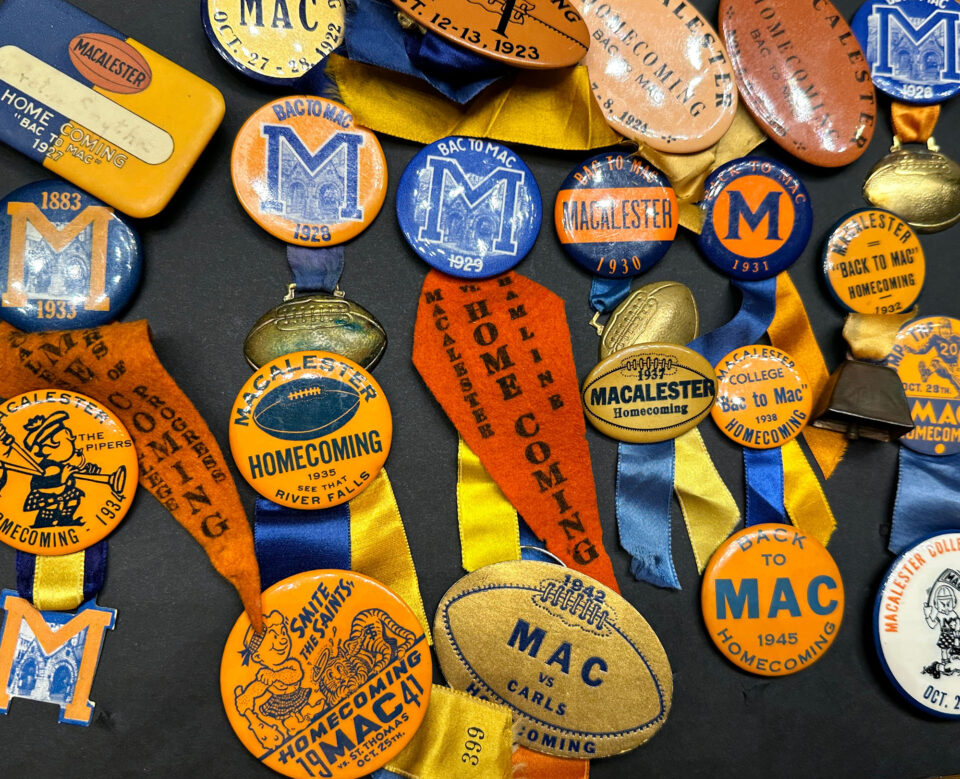 Historical blue and orange buttons and ribbons associated with Macalester College Athletics