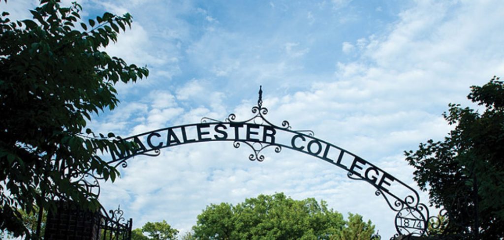 An iron gate with the text "Macalester College"