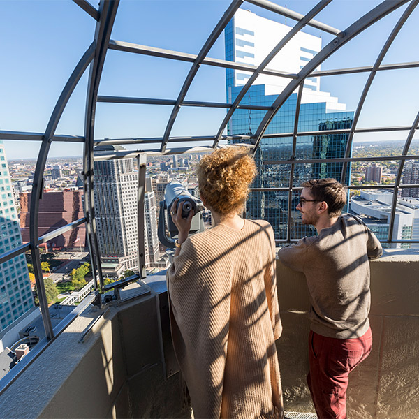 Students looking out from a Minneapolis skyscraper observation deck.