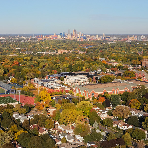 Aerial photo of the Macalester campus with Downtown Minneapolis in the background.