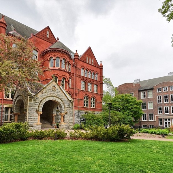 Old Main, a red brick building with a large gray stone entryway, and Carnegie Hall on Macalester's campus