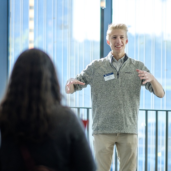 A Mac student speaking to visiting high school students