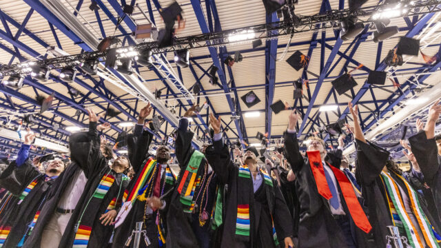 The Class of 2026 throws their caps in the air at Commencement.