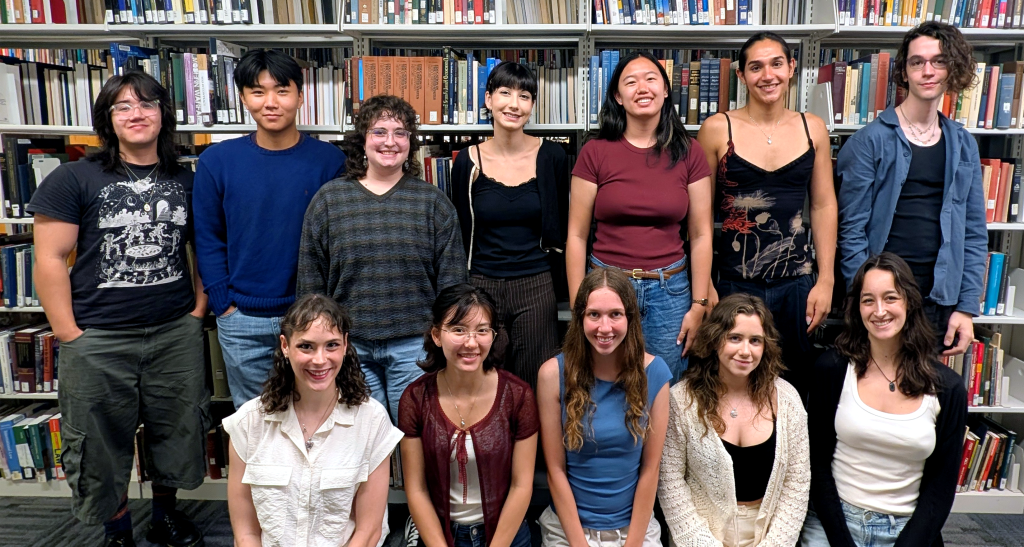 A group photo of 12 college undergraduates employed as peer writing tutors.