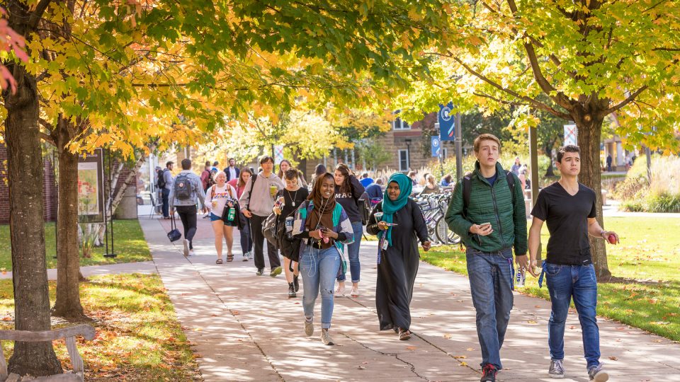 Students walking on the Macalester campus in autumn.