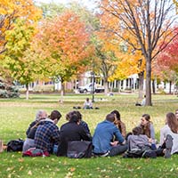 Photo of a class meeting outside on an autumn day