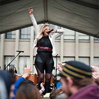 Photo of a Springfest performer jumping up and down on stage