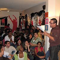 Photo of a crowd of students listening to a slam poet