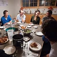 Photo of students gathered over dinner