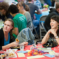 Photo of students sitting at a table at Sophomore Fiesta