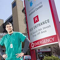 Photo of a student standing in front of Hennepin County Medical Center