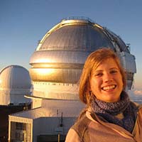 Photo of a student in front of the Macalester observatory