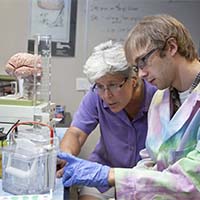 Photo of a student and a professor working together in a science lab