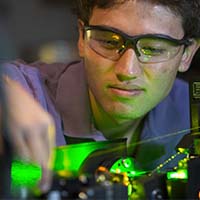 Photo of a student wearing googles and working on a project