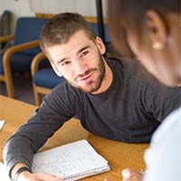 Photo of one student tutoring another