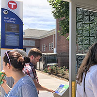 Photo of three students standing at the A-line station