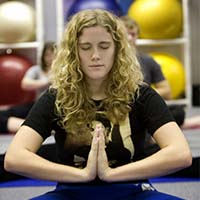 Photo of a student doing yoga in the gym