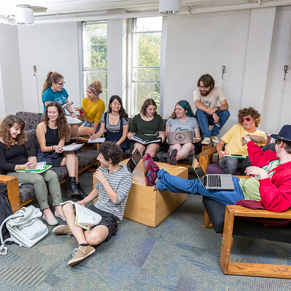 Students talking in a residence hall common room.