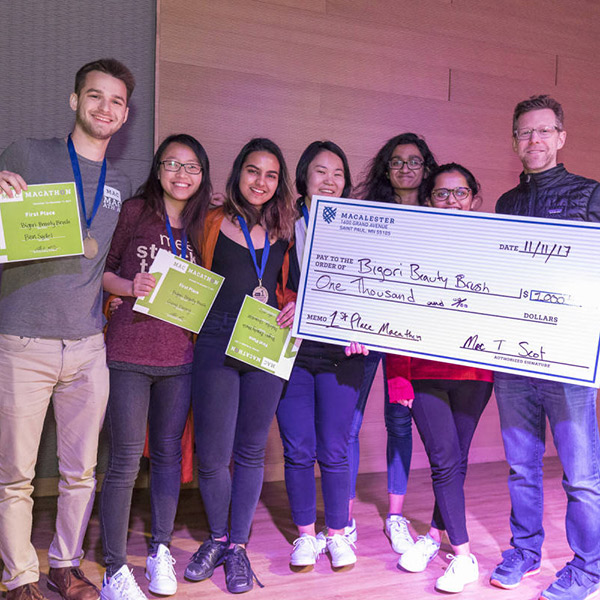 Photo of a group of students holding a giant check