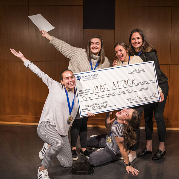 Photo of a group of students holding a giant check