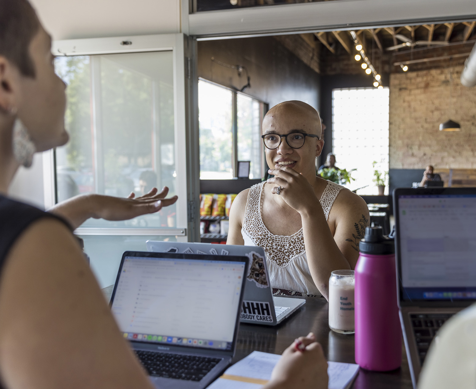 Student Ben Levy and two coworkers using laptops at the site of their Chuck Green Fellowship.