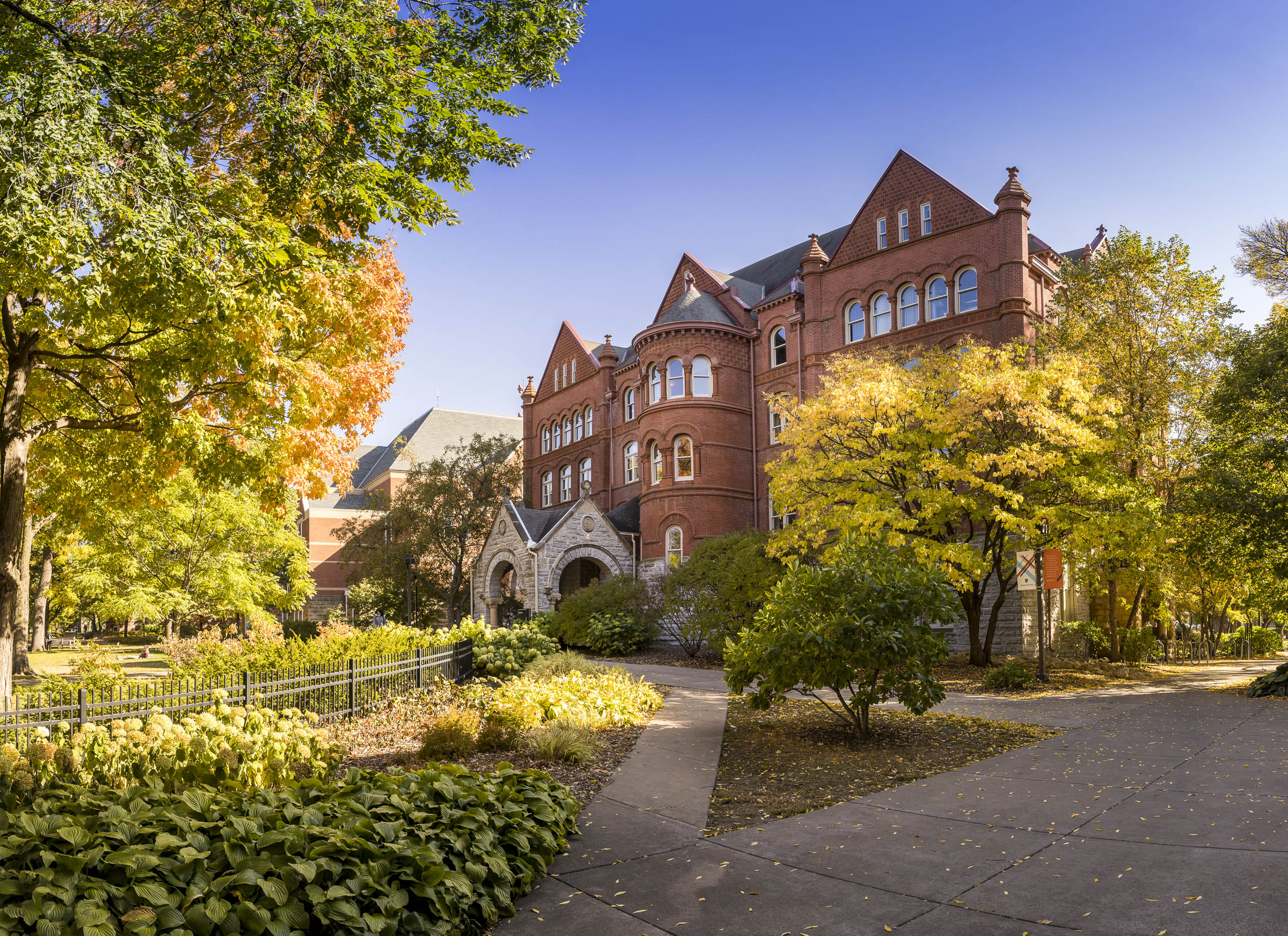 Macalester campus at golden hour, with rich foliage surrounded Old Main.