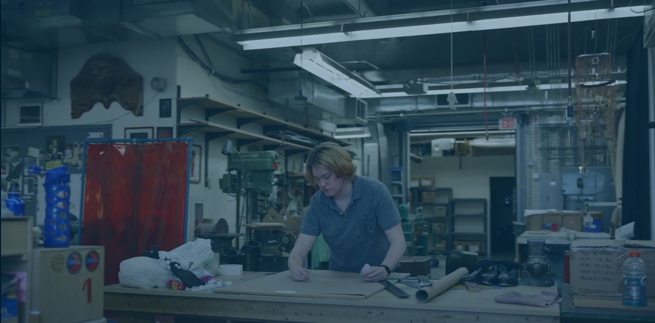 A student participates in an internship in a theater studio workshop.