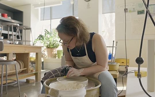 Ellie Barnes working at a pottery wheel
