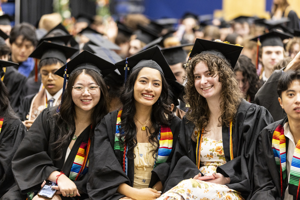 Three smiling 2025 graduates.