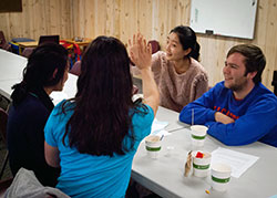 Students sitting around a table talking