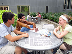 Students sitting at an outdoor table talking