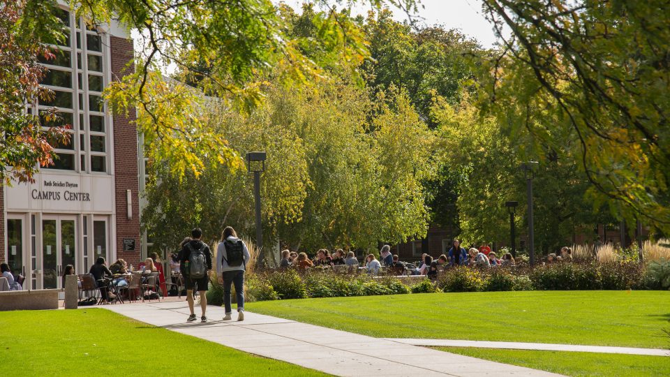 Photo of students walking in front of the Campus Center building.