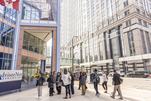 Group of students walks toward an insurance agency in downtown Minneapolis