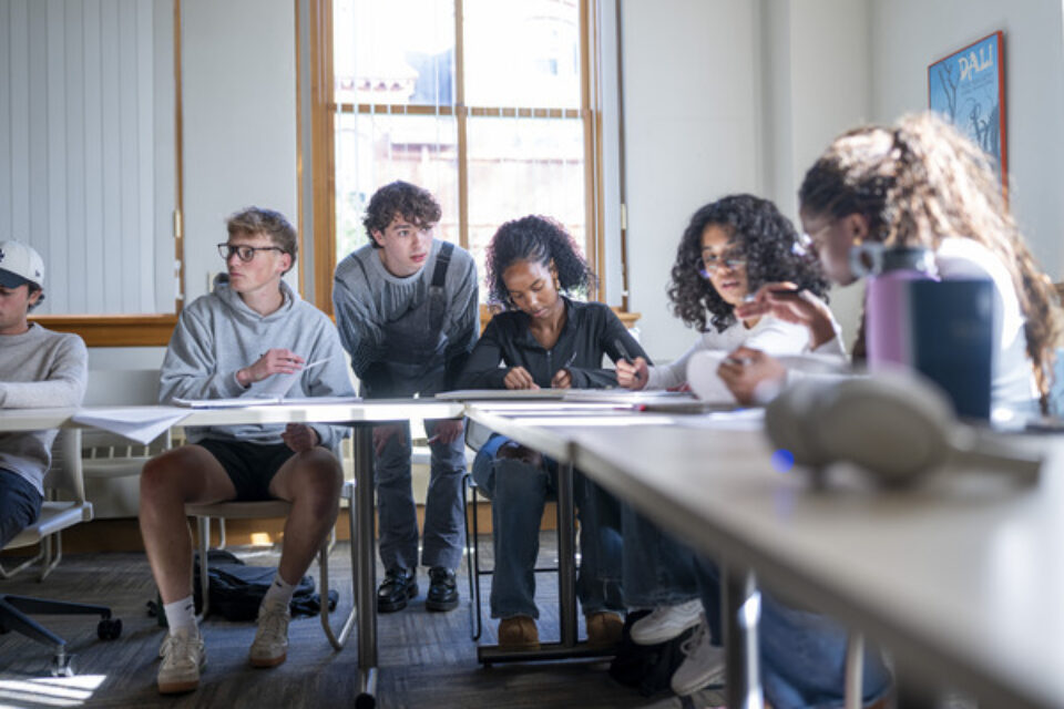 Students working in a group in a college classroom.