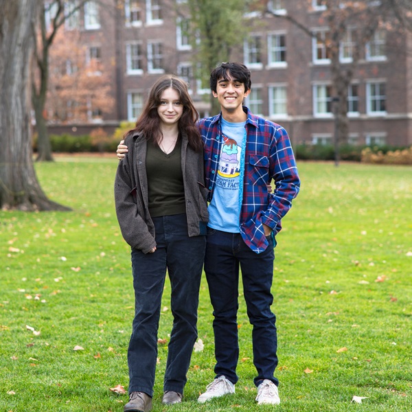 Two members of the Policy Debate team pose together on Macalester's Great Lawn.