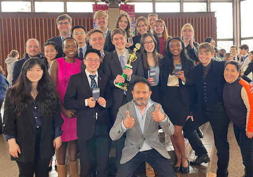 Members of Macalester's Mock Trial team pose with a trophy and other awards.