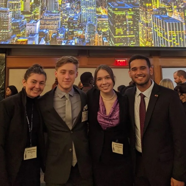 Four members of the Model UN team pose together at an event.