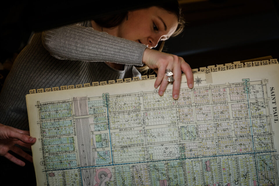 Student turns the page of an atlas