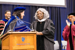 Ms. Leona Tate is congratulated by President Rivera after receiving her honorary degree at Convocation.