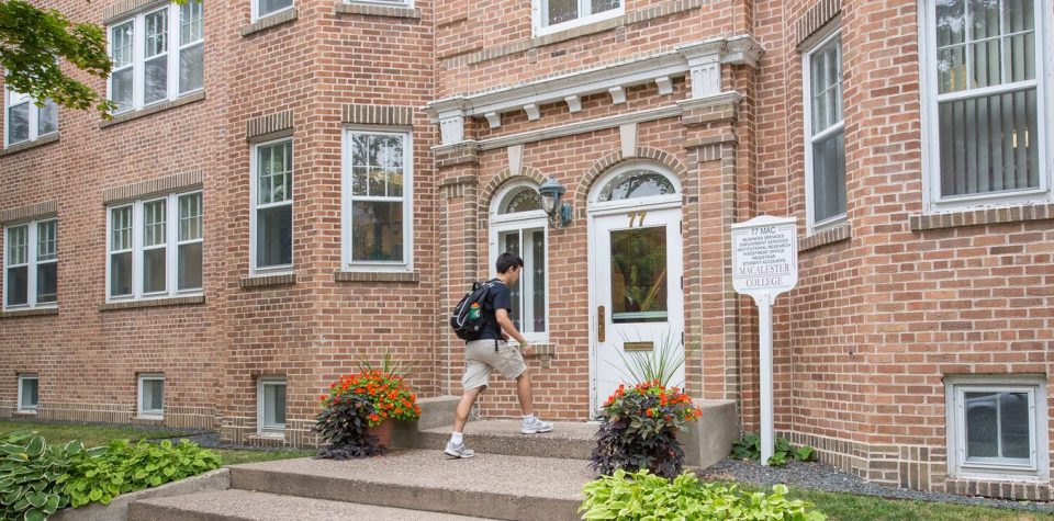 A student entering the front door of the 77 Mac building