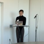 This is a photo of scholar Gabriel Gonzalez presenting his research.