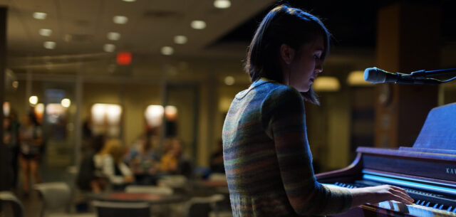 Student playing a piano