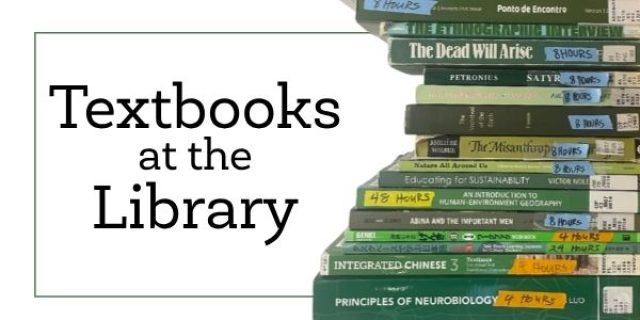 Stack of textbooks with library barcodes on them