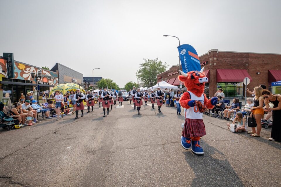 Coo walks ahead of the Macalester College Pipe Band in the Grand Old Days parade.