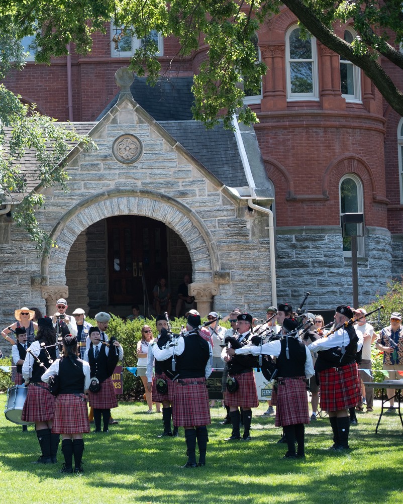 The Macalester pipe band plays outside of Old Main