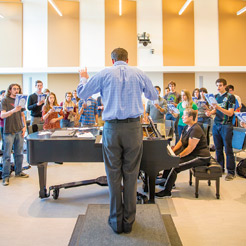 Mike McGaghie conducting choir students during class