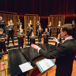 Mike McGaghie conducting a choir rehearsal 