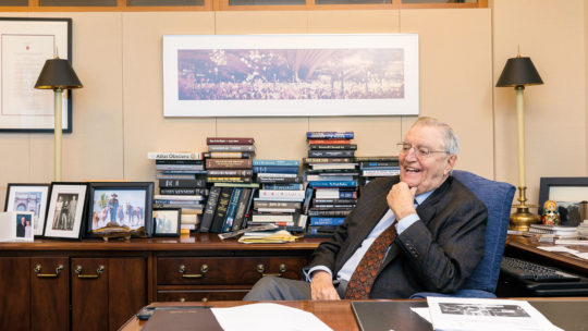 Photo of Walter Mondale sitting at a desk.